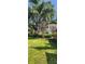 Well-manicured front lawn showcasing home's facade and mature trees at 219 24Th W St, Bradenton, FL 34205