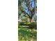 Scenic front yard view, enhanced by lush greenery and mature trees at 219 24Th W St, Bradenton, FL 34205