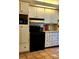 Functional kitchen with classic white cabinets, black appliances, and neutral backsplash at 219 24Th W St, Bradenton, FL 34205