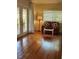 Sunlit living room featuring hardwood floors, a red sofa, and French doors at 219 24Th W St, Bradenton, FL 34205