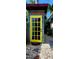 A backyard shed featuring a bright yellow door and natural wood siding at 219 24Th W St, Bradenton, FL 34205