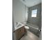 Bathroom featuring modern vanity, tub, and tile accents and a natural light window at 2323 Zuyder Ter, North Port, FL 34286
