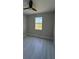 Neutral bedroom featuring tile floors, a ceiling fan, and a sunlit window at 2323 Zuyder Ter, North Port, FL 34286