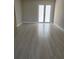 Bedroom features neutral walls, new tile flooring, and access to the backyard at 2323 Zuyder Ter, North Port, FL 34286