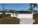 Charming single-story home features a three-car garage, well-maintained lawn, and a modern design at 2323 Zuyder Ter, North Port, FL 34286