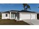 Beautiful single-story home with a three-car garage, landscaped front yard, and stylish front entry at 2323 Zuyder Ter, North Port, FL 34286
