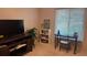 Cozy bedroom features a desk, TV, shelving and a bright window view at 2841 74Th St W # 2841, Bradenton, FL 34209