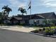 Exterior of the community clubhouse with mature trees, lush bushes and dedicated parking spaces at 2841 74Th St W # 2841, Bradenton, FL 34209