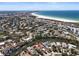 Expansive aerial view showcasing the neighborhood, nearby beach, and scenic waterfront property at 30 Island Cir, Sarasota, FL 34242