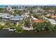 Aerial view of a waterfront home community with private boat docks, landscaping, and mature trees at 30 Island Cir, Sarasota, FL 34242