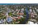 Sprawling aerial shot of the neighborhood with canals, boat docks, and convenient beach access at 30 Island Cir, Sarasota, FL 34242