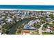 Gorgeous aerial view of a waterfront home with a nearby beach, city, and water access at 30 Island Cir, Sarasota, FL 34242