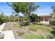 View of a spacious backyard featuring a covered patio and mature trees providing ample shade at 30 Island Cir, Sarasota, FL 34242