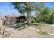 Spacious backyard featuring a covered patio, stone pathway and beautiful landscaping at 30 Island Cir, Sarasota, FL 34242