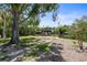 Backyard view features mature trees, landscaping, and a private boat dock on the canal at 30 Island Cir, Sarasota, FL 34242