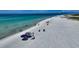 Aerial view of a beautiful beach with clear turquoise water and white sand at 30 Island Cir, Sarasota, FL 34242