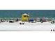 Beautiful beach scene with lifeguard tower, umbrellas, and people enjoying the sunny day at 30 Island Cir, Sarasota, FL 34242