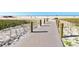 A scenic beach access path leads to a sandy beach with clear skies in the background at 30 Island Cir, Sarasota, FL 34242