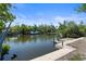 Canal view featuring a dock and boat lift, surrounded by mature trees at 30 Island Cir, Sarasota, FL 34242