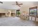 Spacious living room with a ceiling fan, exposed framing, and an outdoor view at 30 Island Cir, Sarasota, FL 34242