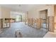 Bright living room featuring a ceiling fan, white walls, and exposed studs at 30 Island Cir, Sarasota, FL 34242