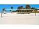 A sunny beach volleyball court with a net, benches and clear blue skies, perfect for recreation at 30 Island Cir, Sarasota, FL 34242