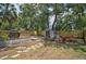 Spacious backyard with a deck, storage shed, and a fire pit area with chairs at 301 W South Ave, Tampa, FL 33603