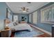 Cozy bedroom with hardwood floors, two windows, and a dresser at 301 W South Ave, Tampa, FL 33603
