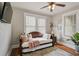 Comfortable bedroom featuring hardwood floors, a ceiling fan, and a day bed with many decorative pillows at 301 W South Ave, Tampa, FL 33603