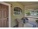 Inviting front porch with wicker seating, perfect for relaxing outdoors at 301 W South Ave, Tampa, FL 33603