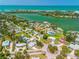 Expansive aerial of a coastal community showcasing waterways, lush trees, and beautifully maintained homes at 302 Pavonia Rd, Nokomis, FL 34275