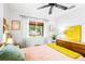 Well-lit bedroom with colorful decor and a large window view to the backyard at 302 Pavonia Rd, Nokomis, FL 34275