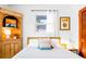 Comfortable bedroom with a rustic cabinet, creating a relaxing retreat at 302 Pavonia Rd, Nokomis, FL 34275