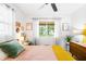 Bright bedroom with lots of light from the large window, complemented by stylish furnishings and art pieces at 302 Pavonia Rd, Nokomis, FL 34275