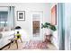 Inviting entryway featuring stylish decor, a colorful rug and ample natural light at 302 Pavonia Rd, Nokomis, FL 34275