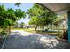Charming home with pea gravel driveway, mature trees and lush, green landscaping at 302 Pavonia Rd, Nokomis, FL 34275