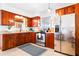 Well-lit kitchen with wooden cabinetry, stainless steel appliances, and granite countertops at 302 Pavonia Rd, Nokomis, FL 34275