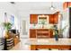Bright kitchen with wooden cabinetry, granite countertops, stainless steel appliances, and a stylish island at 302 Pavonia Rd, Nokomis, FL 34275
