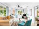 Bright and airy living room featuring a comfortable sofa, stylish furnishings, and large windows at 302 Pavonia Rd, Nokomis, FL 34275