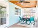 Cozy sunroom featuring a wooden ceiling, ceiling fan, and a casual outdoor dining space at 302 Pavonia Rd, Nokomis, FL 34275