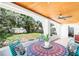 Charming sunroom overlooking a lush backyard with a casual dining set and ample natural light at 302 Pavonia Rd, Nokomis, FL 34275