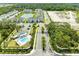 Aerial view of the community featuring a pool, townhomes, and scenic landscaping at 305 Via Tuscany Ave, Sarasota, FL 34243