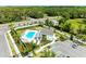 Aerial view of the community pool area and clubhouse, surrounded by lush greenery at 305 Via Tuscany Ave, Sarasota, FL 34243