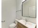 Bright powder room featuring a modern sink and vanity, with a sleek mirror above at 305 Via Tuscany Ave, Sarasota, FL 34243