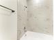 Close-up of updated bathroom featuring marble-look tile surround the bathtub at 305 Via Tuscany Ave, Sarasota, FL 34243