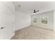 Bright bedroom with neutral carpet, ceiling fan, closet, and two windows at 305 Via Tuscany Ave, Sarasota, FL 34243