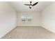 Spacious bedroom with plush carpeting, a ceiling fan, and dual windows allowing for ample natural light at 305 Via Tuscany Ave, Sarasota, FL 34243