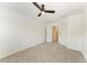 Bedroom with neutral carpet and a ceiling fan leading to a closet at 305 Via Tuscany Ave, Sarasota, FL 34243