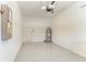 Epoxy floor in a clean garage featuring a water heater and electrical panel at 305 Via Tuscany Ave, Sarasota, FL 34243
