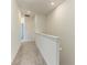 Upstairs hallway with plush carpet, white walls, and doorways leading to other rooms at 305 Via Tuscany Ave, Sarasota, FL 34243